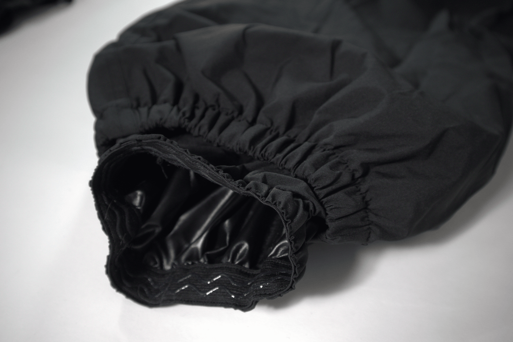 Black baggy snow pants close up on snow gathers on a white background