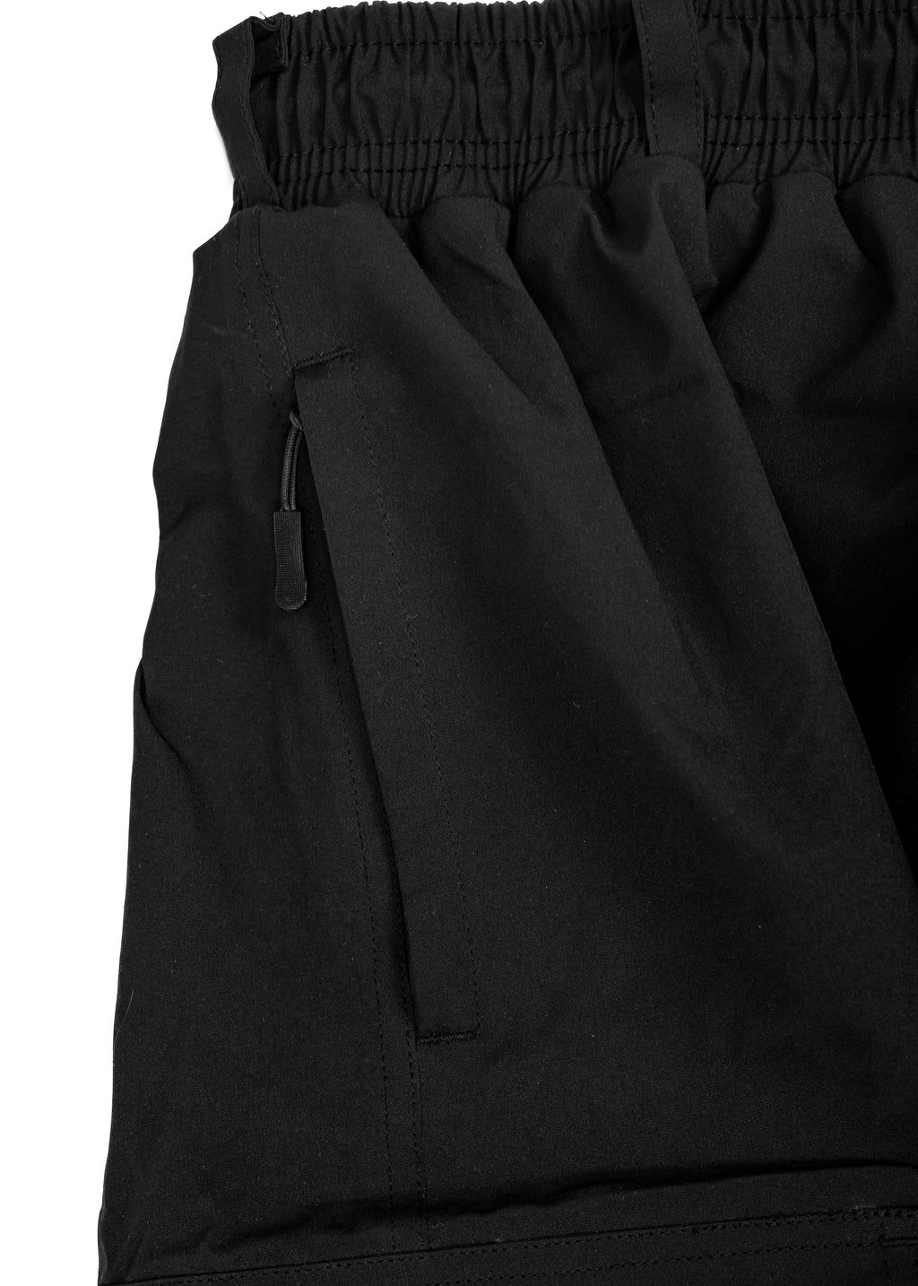 Close-up of black Polar Pursuit  snowpants with a pocket on a white background