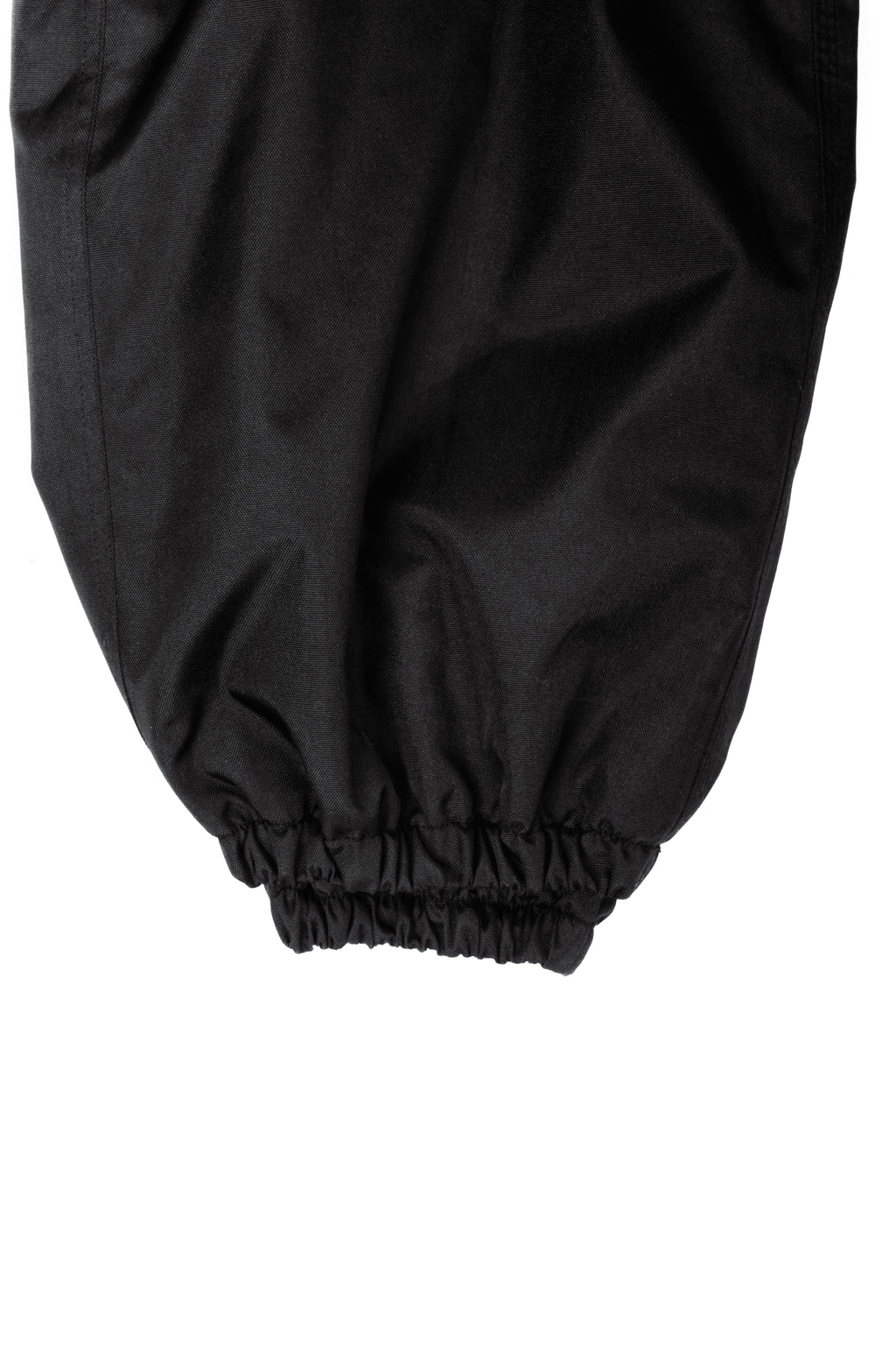 Close-up of black Polar Pursuit snowpants with a white background