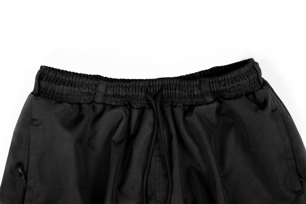 Close-up of black Polar Pursuit pants on a white background