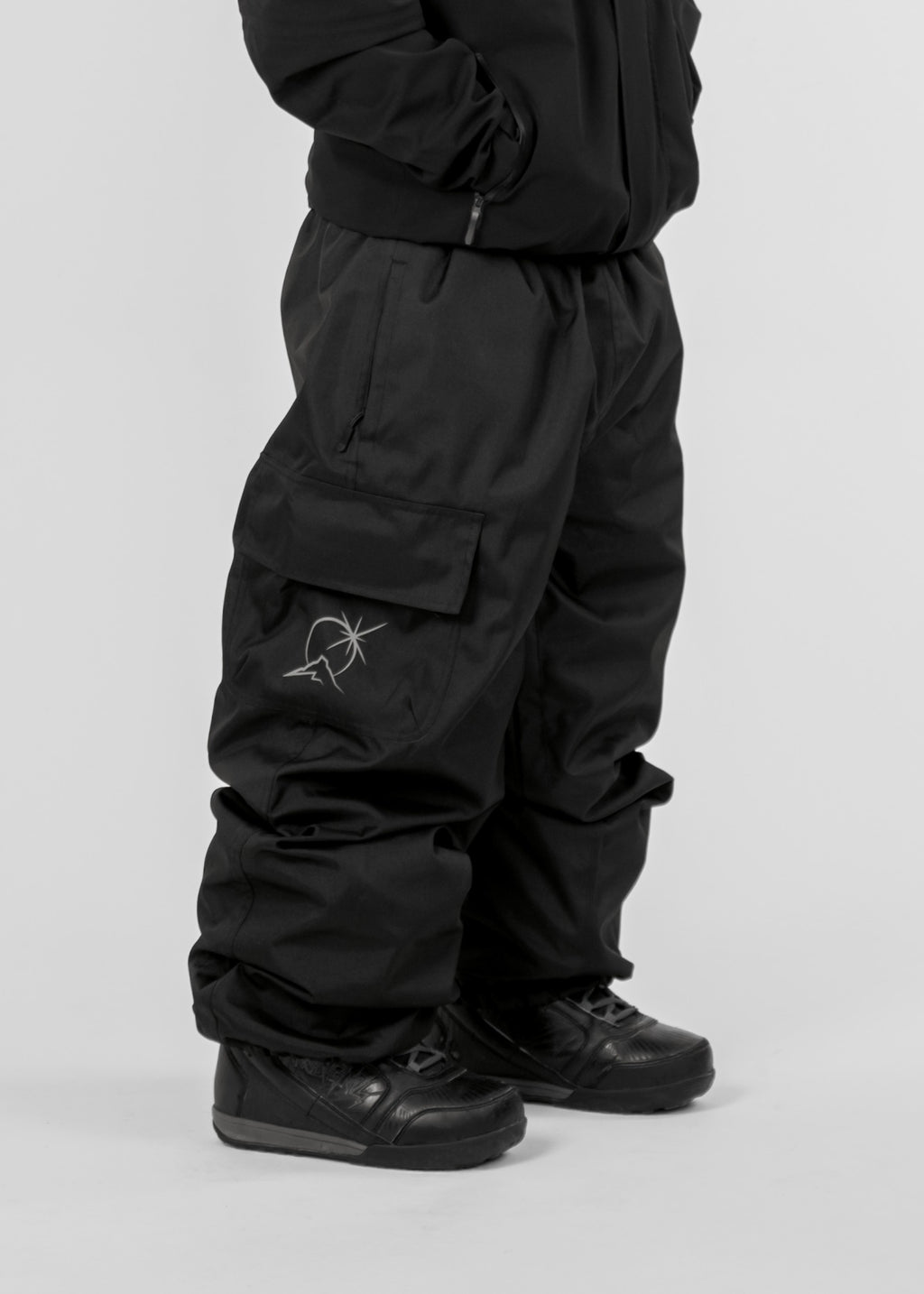 Black Polar Pursuit snowpants with a Polar Pursuit logo on a white background (Tom is 160cm 68kg wearing size M)