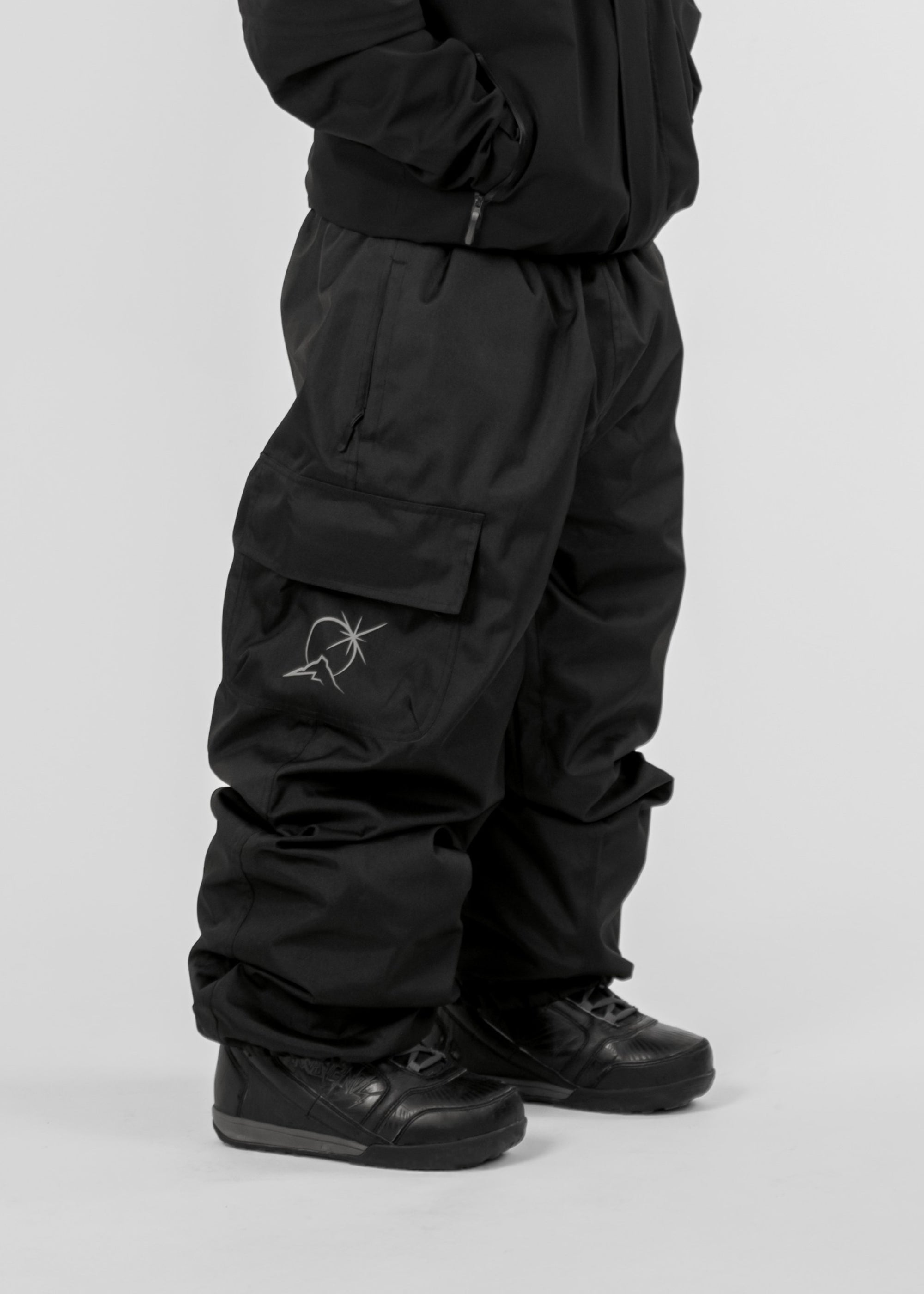 Black Polar Pursuit snowpants with a Polar Pursuit logo on a white background (Tom is 160cm 68kg wearing size M)